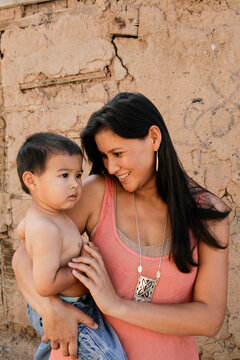 Native American Mother Holding Baby Outdoors Showing Love and Care