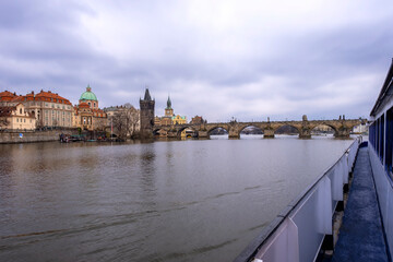 Fototapeta premium View of the Charles Bridge, that cross the Vltava river in the old centre of Prague. Built in the XII century and decorated by several religious statues, it is the most famous bridge of Prague.