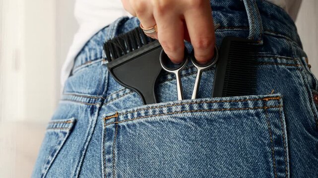 Woman tucking scissors into pocket , salon and beauty tools for professionals.