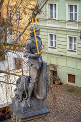 Medieval statue that decorate the sides of the famous Charles Bridge, over the Vltava River that runs through the city of Prague. © stefanopez