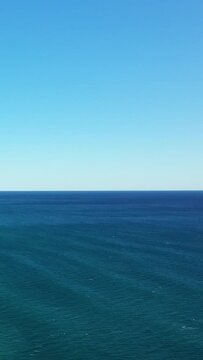 Tranquil seascape with deep blue water and clear sky, captured off the coast of Acciaroli, Italy. Perfect for concepts of serenity, nature, and travel.