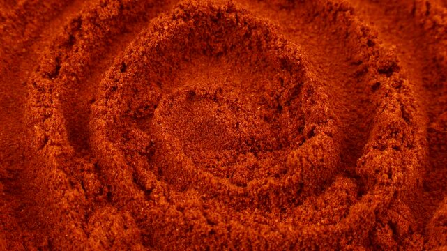 Red smoked paprika powder circle rotation close up