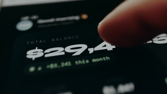 Person view the financial summary from an application, Total account balance and monthly earnings, close-up view