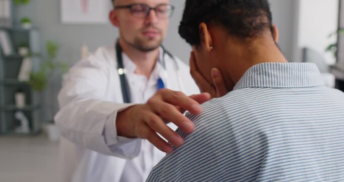 Doctor and woman patient during clinic consultation. Physician support frustrated sick patient in medical office during examination. Medicine and supportive healthcare guidance and care concept.