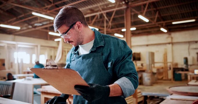 Man, carpenter and writing with clipboard in workshop for furniture, lumber or timber project. Male person, checklist and material with woodwork for inventory, online order or carpentry distribution