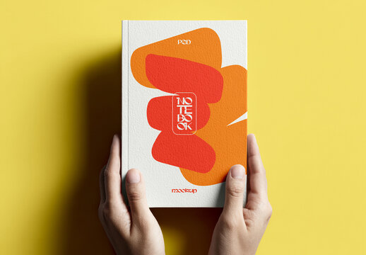 Notebook Mockup in Hands with Solid Background