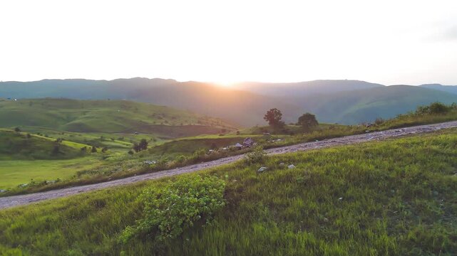 Golden Hour Aerial View of Rayta Hill Udaipur Sunset over Lush Green Mountains in Rajasthan