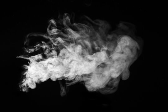 White hot horizontal curly steam smoke isolated on black background. Abstract background, design element, for overlay on pictures. Create mystical Halloween photos, for overlay on pictures