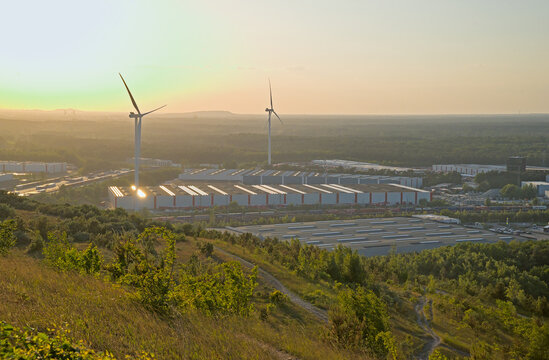 High angle view on warehouses and wind mills against a sunset sky in Genk, Flanders, Belgium 