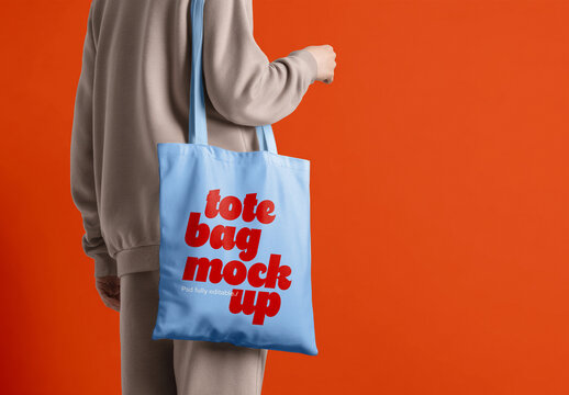 Tote Bag Mockup In Hand with Solid Studio Background