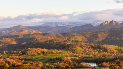Naklejka premium Sunset over Peña Cabarga mountains and Pisueña Valley, Penagos, Cantabria, Spain.