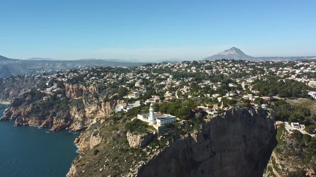 Aerial drone footage of Faro del Cabo de la Nau on Mediterranean coast, Spain.