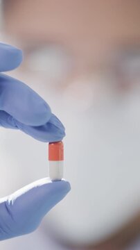 Medical, solution or hands in lab with pill, drug testing or product exam in vaccine development. Research, person or scientist with medication, breakthrough or capsule cure in pharmaceutical study.