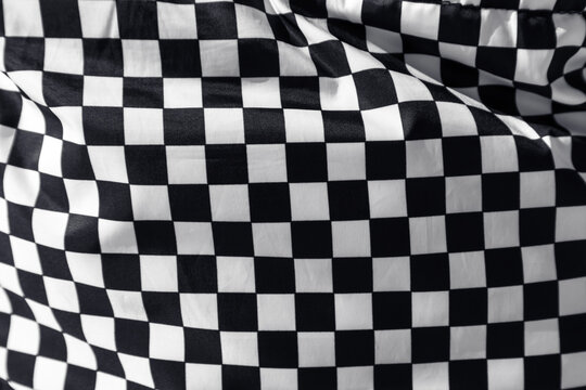 Checkered flag. Finish flag. Fabric with a texture of black and white squares