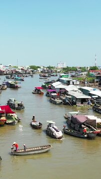 Traditional boats gather on a busy river at Cai Rang floating market in Vietnam, showcasing vibrant local commerce and daily life on the water.