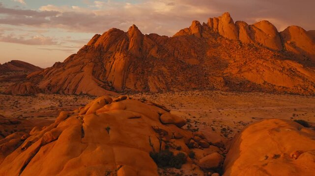 Drone shot over Spitzkoppe in Namibia desert sunset cinematic