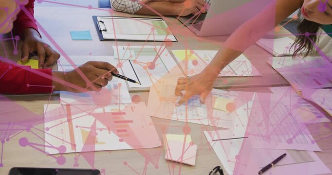 Vertical video: Pointing red sleeve man indicating data with pen, woman aligning charts at table