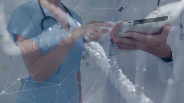 Dr scrolling tablet, nurse pointing, consulting genome data with animated DNA overlaying foreground