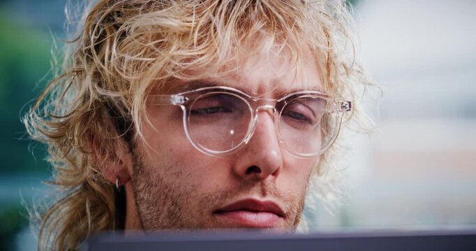 Creative, glasses and businessman with laptop in office, proofreading and editing article on website. Magazine editor, eyewear and person with tech for media publication, online or review in newsroom