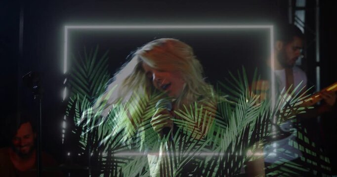 Lead singer touching hair, starting LED frame and palm over band singing mic, bassist playing music