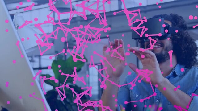 Man with VR headset raising hands and activating particle net in tech hub, visualizing magenta web