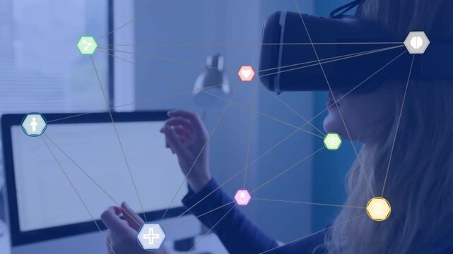 Interacting VR-headset woman dark top gesturing at desk with monitor lamp hexagon nodes, copy space