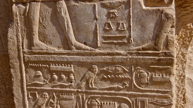 Karnak Temple in Luxor, Egypt. Close-up ancient Egyptian wall relief with pharaoh and gods figures, cartouche and hieroglyphics at Karnak Temple Luxor. Authentic history and documentary.