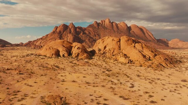 Drone shot over Spitzkoppe in Namibia desert sunset cinematic