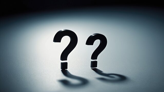 Two black question marks on a blue surface