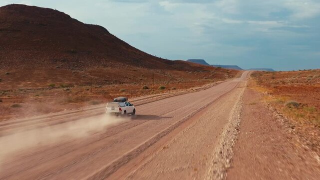Drone shot with riding 4x4 car in Namibia desert.