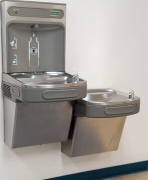 Modern drinking water fountain with bottle filling station on wall