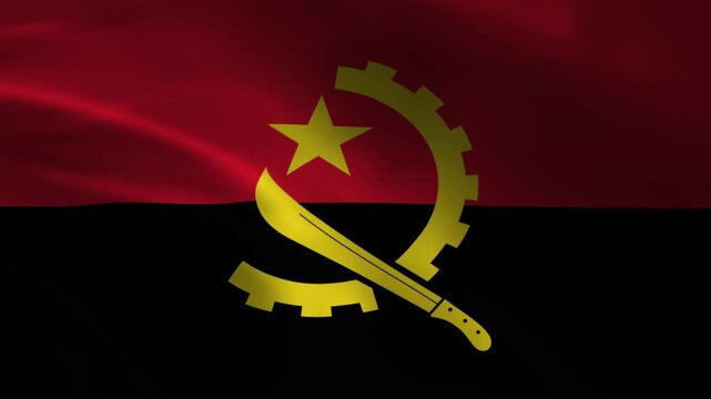 Angola national flag waving close up with yellow emblem featuring machete cog wheel and gold star