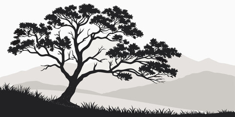 A solitary tree stands tall on a hill with a scenic mountain backdrop at sunset. © Murad