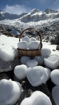 Creating a creative concept in the mountains by shaping the snow into hearts.