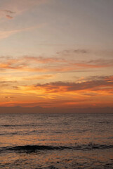 Fototapeta premium Beautiful sunset over the sea with orange sky and calm waves at the beach