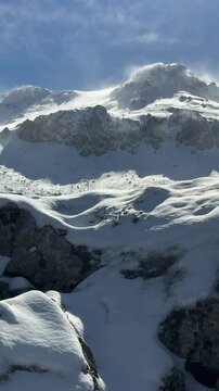 Winter's texture on the mountain peaks, misty and mystical landscapes of windswept summits.