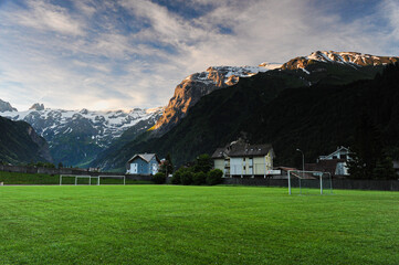 Green soccer field in the valley with the Titlis mountains  © hong