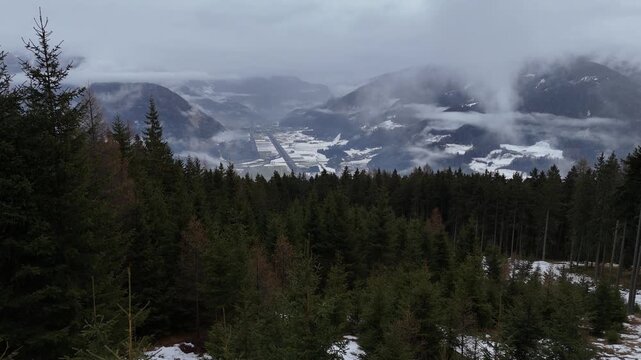 Cinematic Drone Forward Flight Over Alpine Pine Forest Toward Vipiteno Town in South Tyrol