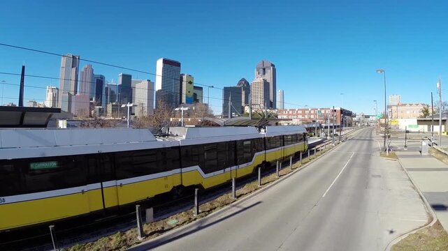 2 Dallas Dart commuter trains pass in front of Skyline from a drone