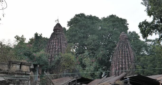 Urban construction is causing damage to an old temple, highlighting heritage destruction and the impact of rapid city development on cultural sites