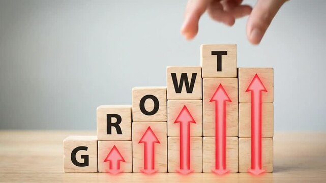 Hand placing wooden growth arrow blocks on rising success chart for business strategy concept