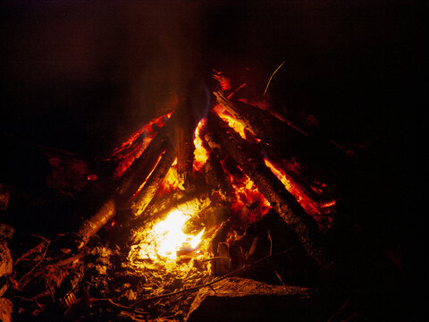 A dark campfire at night, closeup