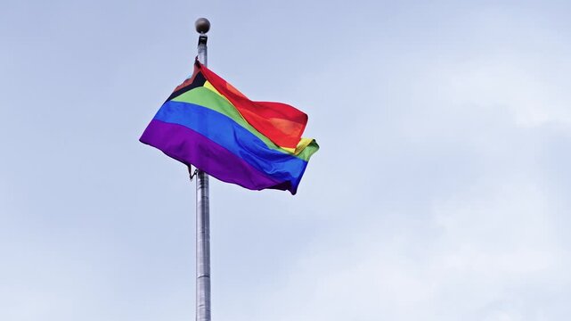 LGBT community. Tolerance and equality. World gay pride. Rainbow gay flag. Pride month. LGBTQ rainbow flag. LGBT rainbow flag waving against sky. Symbol of pride and LGBTQ. Colorful pride flag