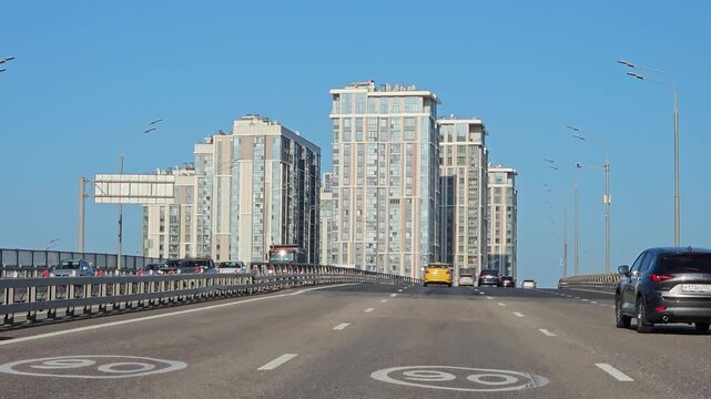 MOSCOW - JUL 26 , 2025: Busy highway with a yellow taxi driving down the road. The taxi is the only vehicle on the road