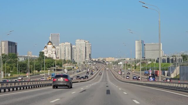 MOSCOW - JUL 26 , 2025: Busy highway with a large sign on the side of the road. The sign is pointing to a city