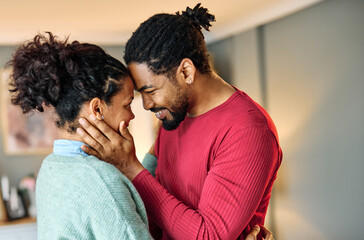 Obraz premium Portrait of a lovely young couple together, bonding hugging and relaxing at home