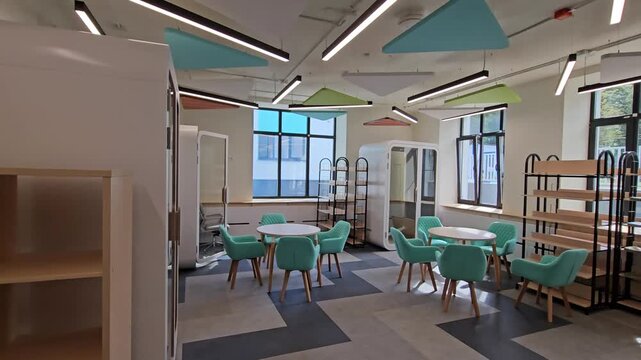 MOSCOW - AUG 25 , 2025: Room school with a lot of chairs and shelves. The chairs are green and the shelves are wooden in renovation renovated school at Day of open doors