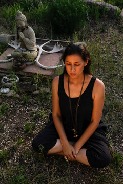 Young Native American woman meditating outdoors in quiet reflection