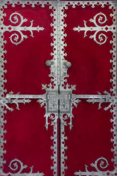 Ornate Red Door covered in velvet and with decorative  metal work 