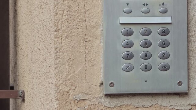 Detailed image of aged security keypad with visible screws and textured surface